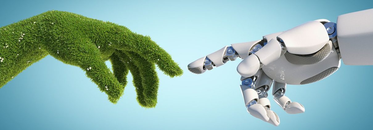 Beitragsbild für Blogbeitrag Green Engineering Energiewende: Eine mit Gras bewachsenen Hand und Hand von Roboter berühren sich fast