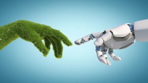 Beitragsbild für Blogbeitrag Green Engineering Energiewende: Eine mit Gras bewachsenen Hand und Hand von Roboter berühren sich fast